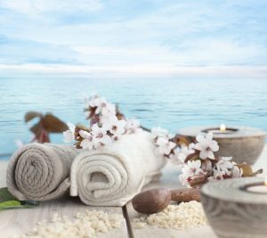 Spa and wellness setting with natural soap, candles and towel. Beige dayspa nature set